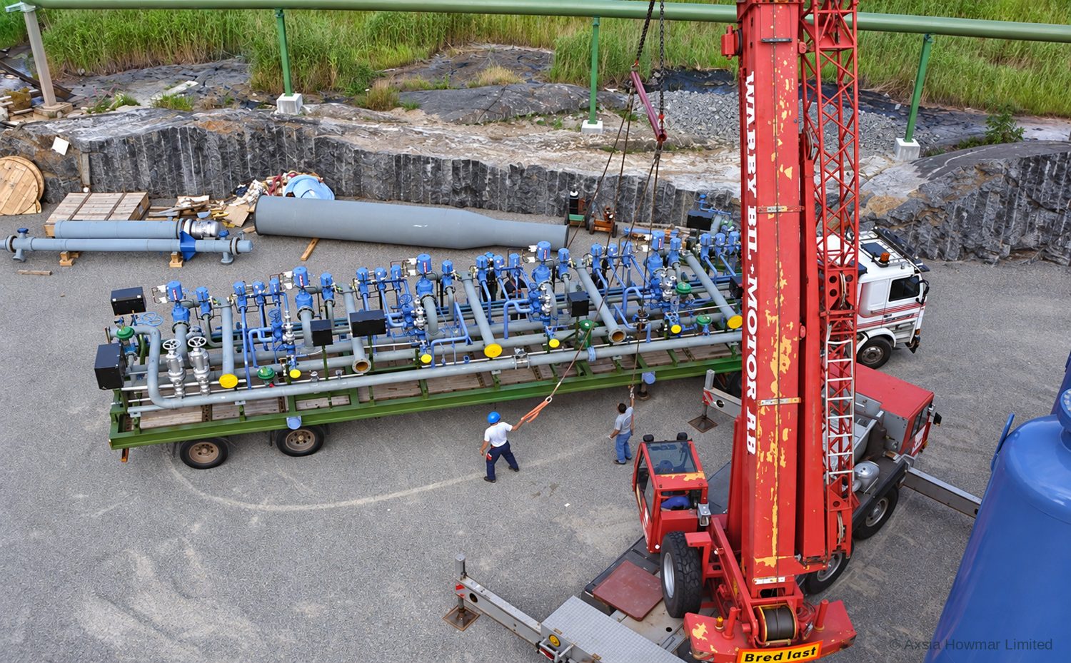 Hydrogen PSA valve skid arriving at site on a low-loader and being lifted onto its foundation.